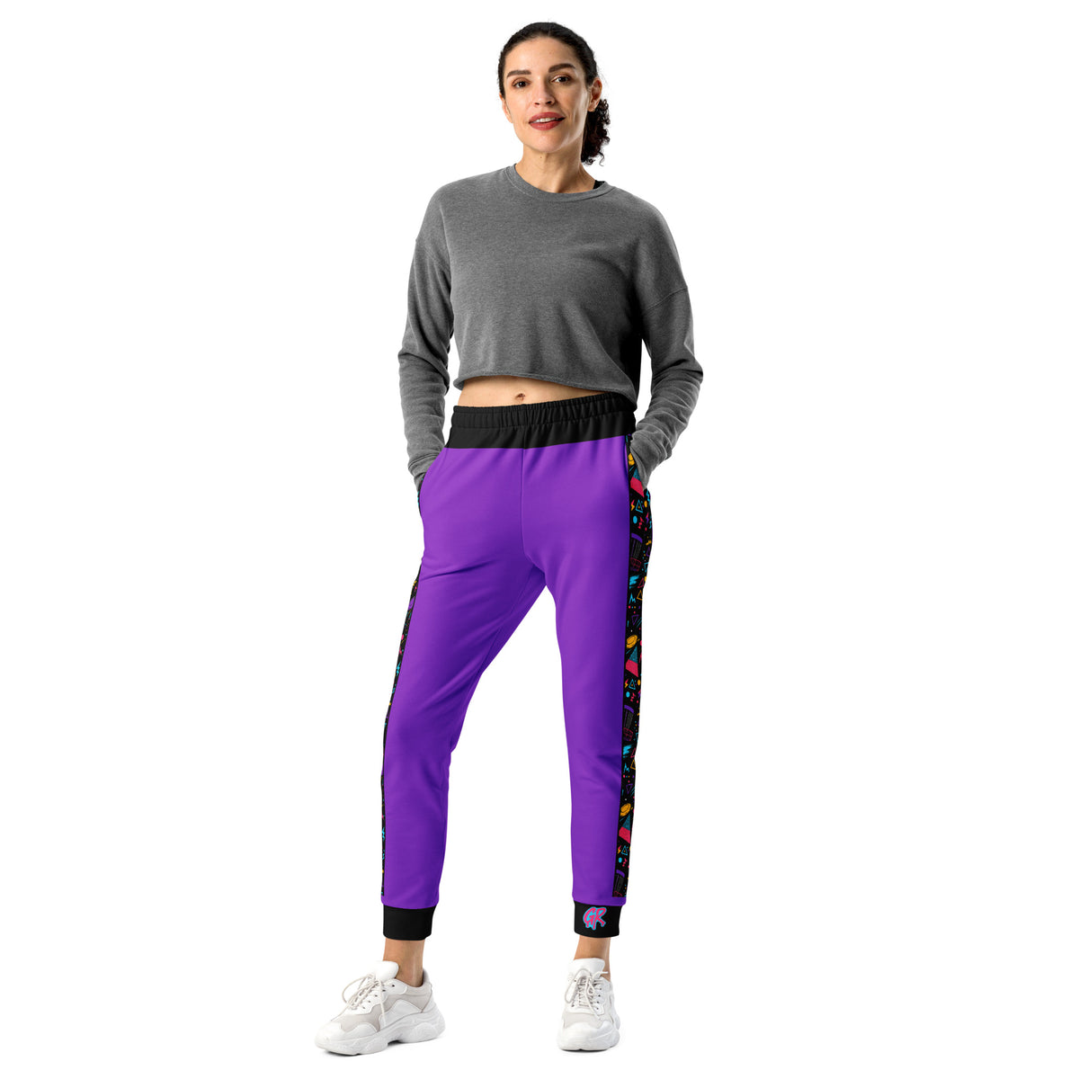 Model wearing the purple Retro Runs women's disc golf joggers, front view, with the 90s side stripe and the GR on the left cuff
