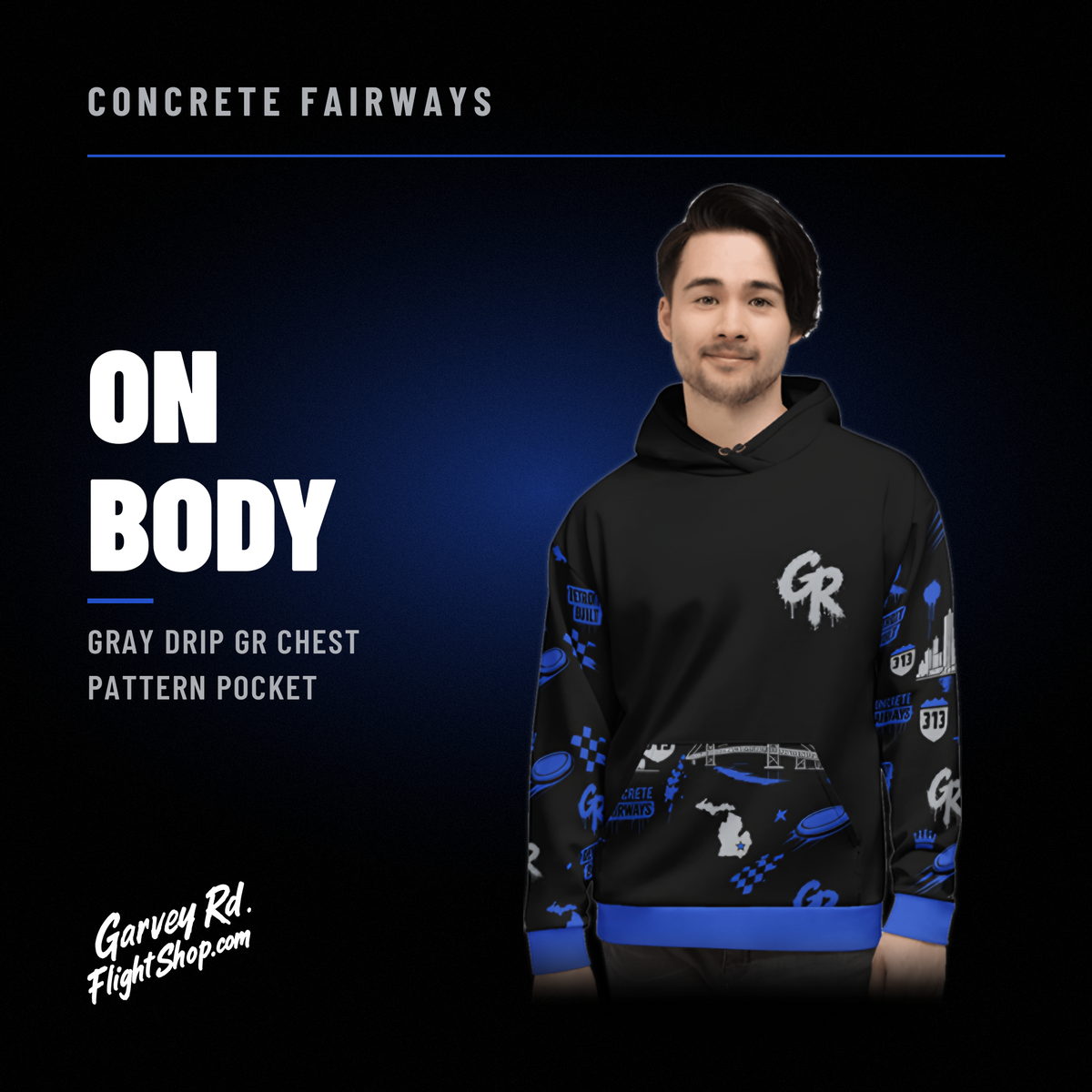 Model wearing the black Concrete Fairways hoodie with gray drip GR on the chest and royal pattern sleeves and pocket