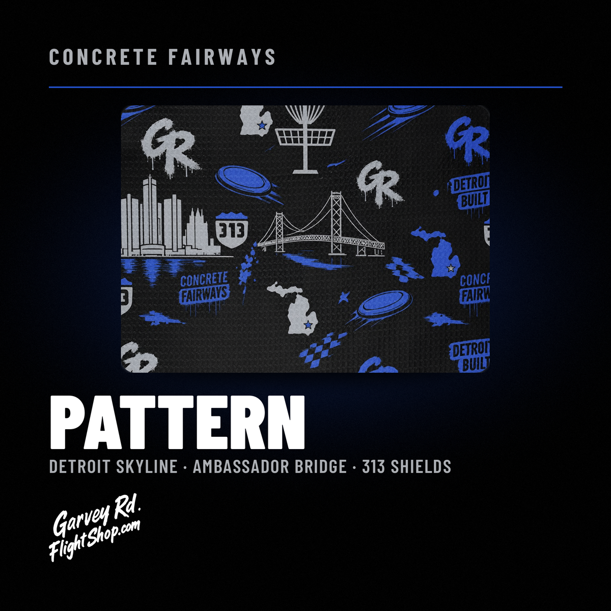 Close-up of the towel pattern: Detroit skyline, Ambassador Bridge, 313 shields and disc golf baskets in royal blue